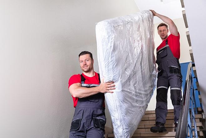 two people disposing of box spring from bedroom in Chestnut Hill, MA